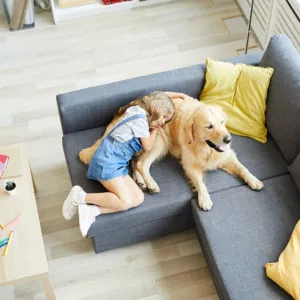 Young girl hugging a dog in their pet-friendly apartment home